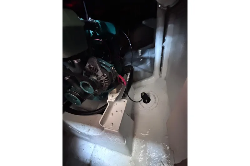 Slide: The Image of Engine compartment of a 1978 Swift 33 boat, featuring mechanical components and wiring. - 29