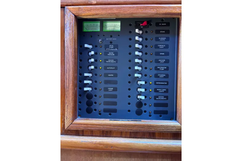 Slide: The Image of Electrical control panel on a 1978 Swift 33 boat, featuring various switches and indicators. - 48
