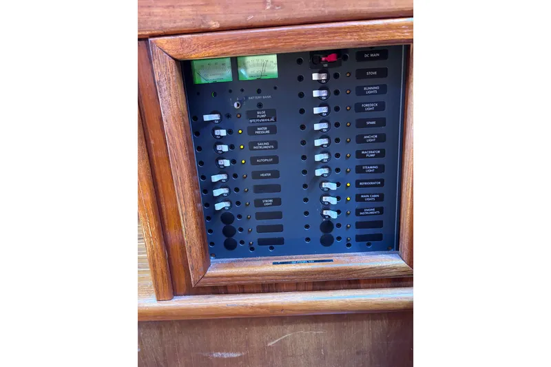 Slide: The Image of Electrical control panel on a 1978 Swift 33 boat, featuring labeled switches and meters. - 47