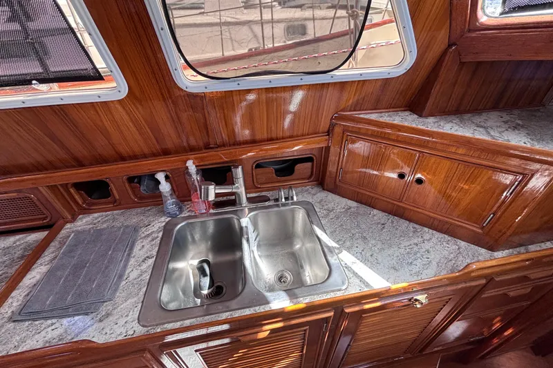 Slide: The Image of 1978 Swift 33 yacht kitchen with wooden cabinets and stainless steel sink. - 21
