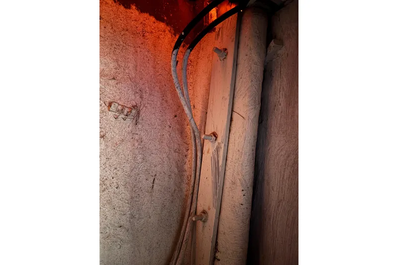 Slide: The Image of Interior view of a 1978 Swift 33 boat, showing cables and bolts. - 33