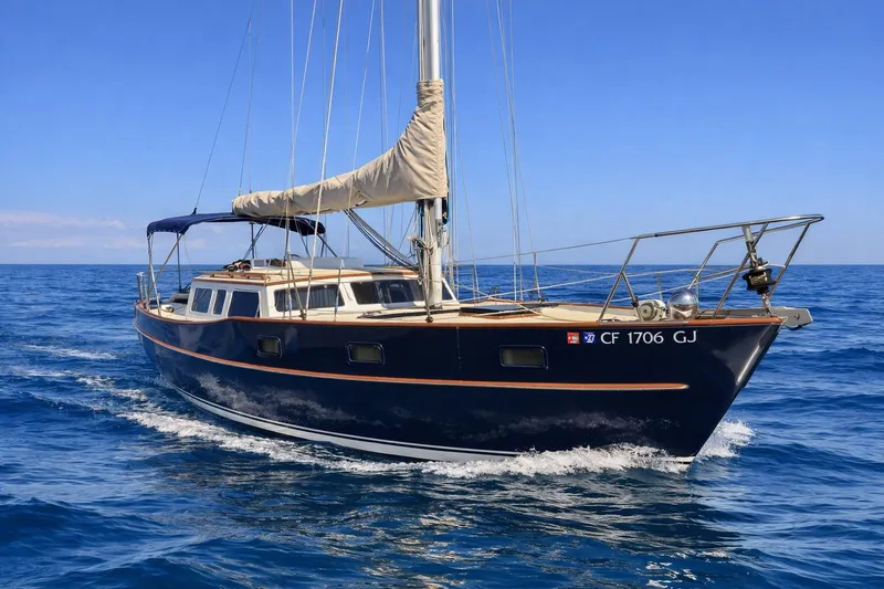 The Image of 1978 Swift 33 sailboat cruising on open blue sea under clear sky. - 0