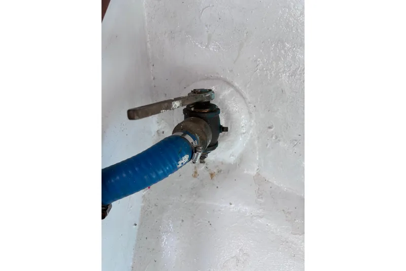 Slide: The Image of Blue hose connected to a metal valve inside a 1978 Swift 33 model. - 61
