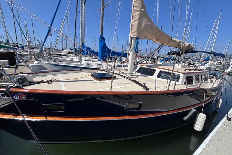 Slide: The Image of 1978 Swift 33 sailboat docked in a marina, surrounded by other boats. - 1