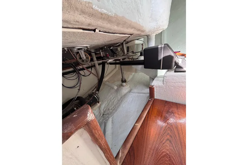 Slide: The Image of Interior view of a 1978 Swift 33 boat showing mechanical components and wooden flooring. - 32