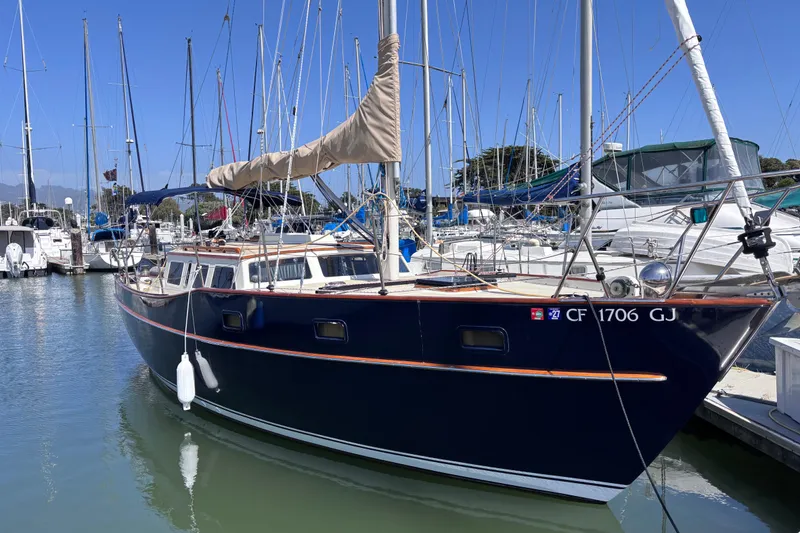 Slide: The Image of 1978 Swift 33 sailboat docked in a marina under clear blue skies. - 2
