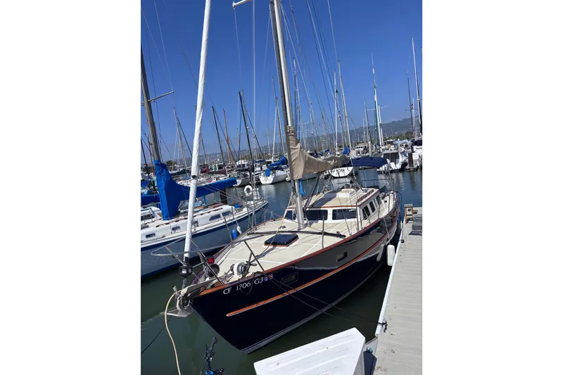 Slide: The Image of 1978 Swift 33 sailboat docked in a marina under clear blue skies. - 4