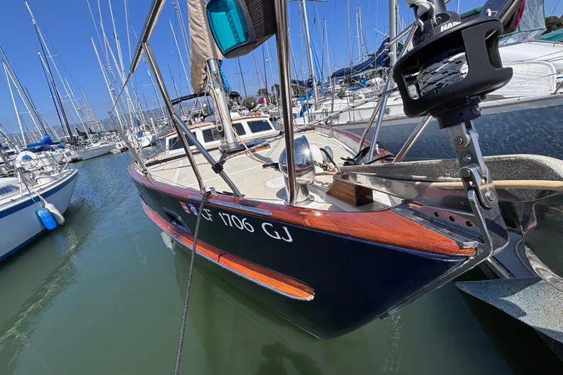 Slide: The Image of 1978 Swift 33 sailboat docked in marina, featuring wooden accents and sleek design. - 8