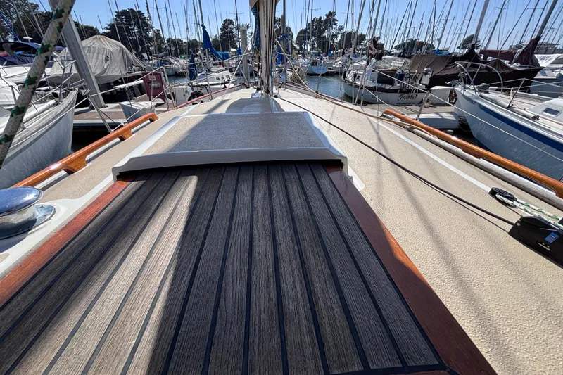 Slide: The Image of 1978 Swift 33 sailboat deck view in marina, surrounded by other boats. - 56