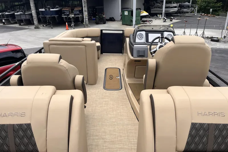 Slide: The Image of Interior view of 2022 Harris Solstice 230 CWDH pontoon boat with beige seating. - 5
