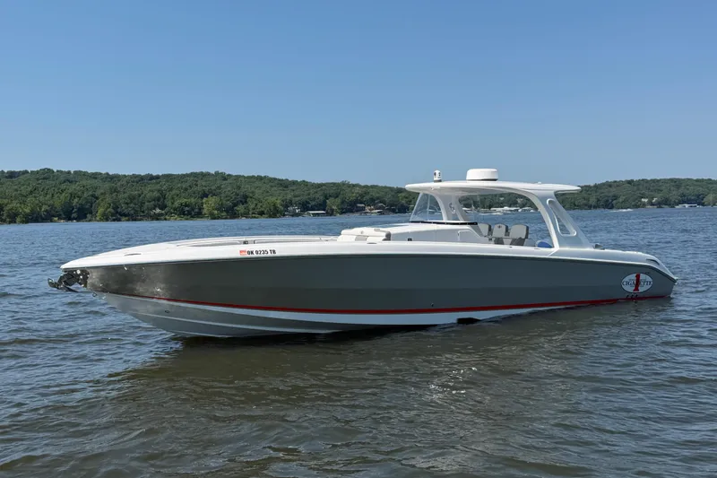The Image of 2015 Cigarette 41' Nighthawk SD Edition boat on a calm lake. - 0