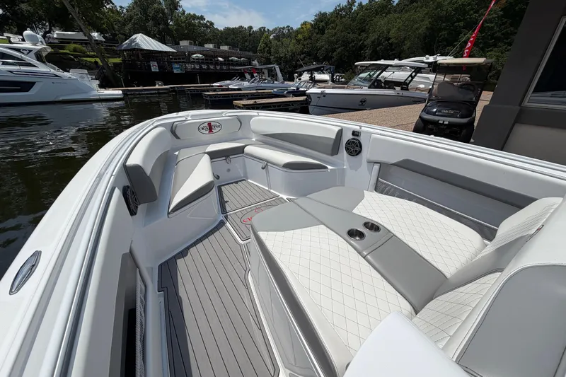 Slide: The Image of 2015 Cigarette 41' Nighthawk SD Edition boat interior with luxurious seating at a marina. - 8