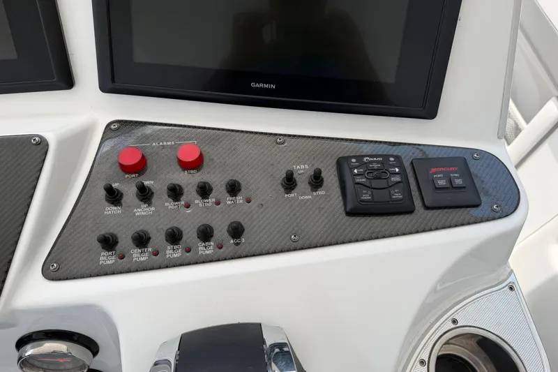 Slide: The Image of Control panel of 2015 Cigarette 41' Nighthawk SD Edition boat with various switches and displays. - 6
