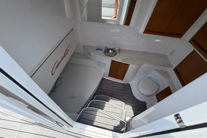 Slide: The Image of Interior of 2015 Cigarette 41' Nighthawk SD Edition boat, featuring a compact bathroom. - 7