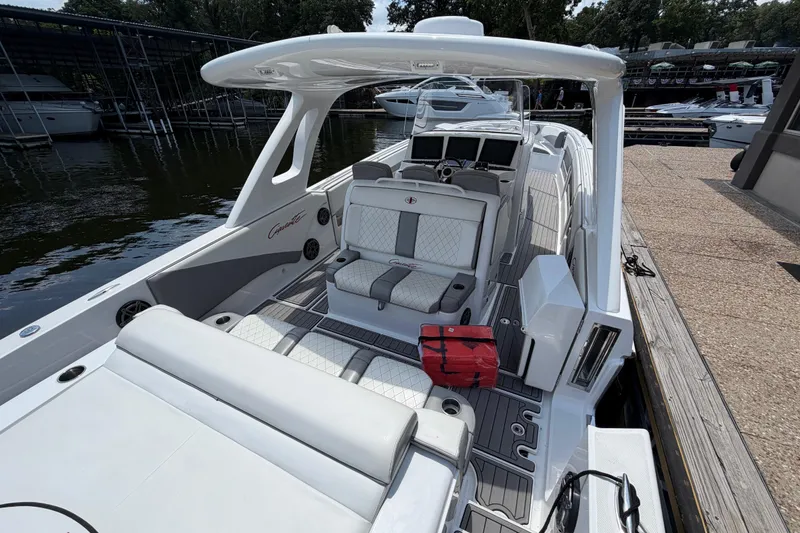 Slide: The Image of 2015 Cigarette 41' Nighthawk SD Edition boat docked, featuring sleek white and gray interior. - 3