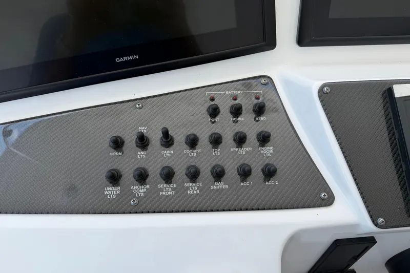 Slide: The Image of Control panel of a 2015 Cigarette 41' Nighthawk SD Edition boat with labeled switches. - 5