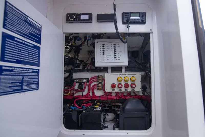 Slide: The Image of Electrical panel of a 2019 Midnight Express 43 Open boat, showcasing wiring and controls. - 17