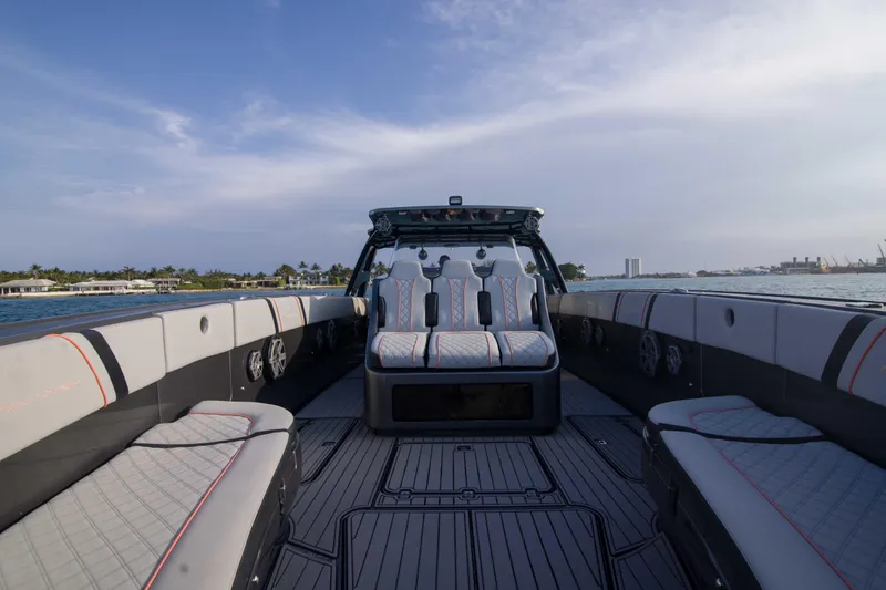 Slide: The Image of 2019 Midnight Express 43 Open boat interior with luxurious seating and scenic water view. - 10