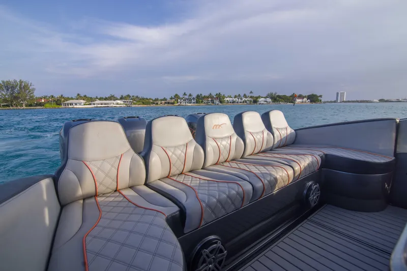 Slide: The Image of Luxurious seating on a 2019 Midnight Express 43 Open boat, cruising near a scenic coastline. - 18