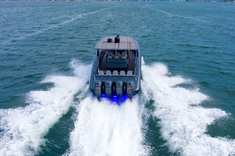 Slide: The Image of 2019 Midnight Express 43 Open speeding on open water, showcasing powerful engines and sleek design. - 25