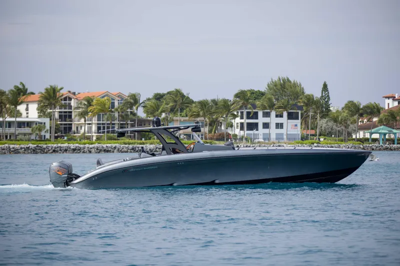 Slide: The Image of 2019 Midnight Express 43 Open boat cruising near coastal homes and palm trees. - 31