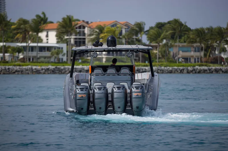 Slide: The Image of 2019 Midnight Express 43 Open boat cruising near coastal homes with four powerful engines. - 29