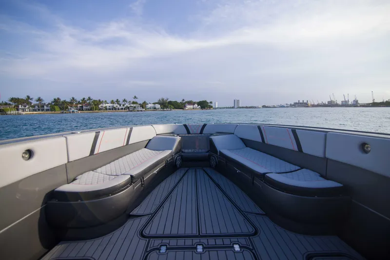 Slide: The Image of 2019 Midnight Express 43 Open boat interior with luxurious seating, cruising on calm waters. - 21