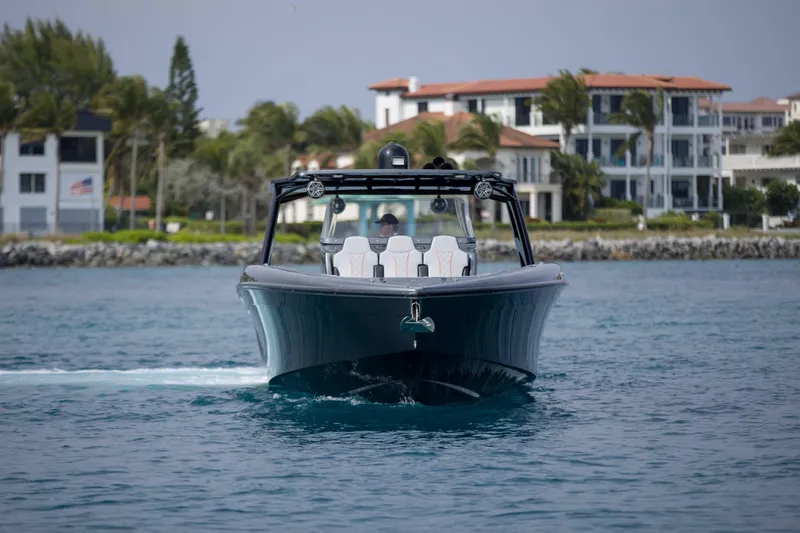 Slide: The Image of 2019 Midnight Express 43 Open boat cruising near luxury waterfront homes. - 3