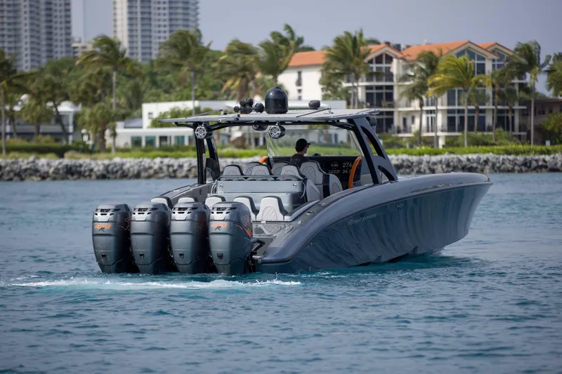 Slide: The Image of 2019 Midnight Express 43 Open boat cruising on water with multiple outboard engines. - 32