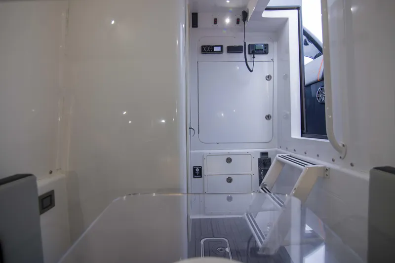 Slide: The Image of Interior of a 2019 Midnight Express 43 Open boat, featuring sleek white design and modern controls. - 15