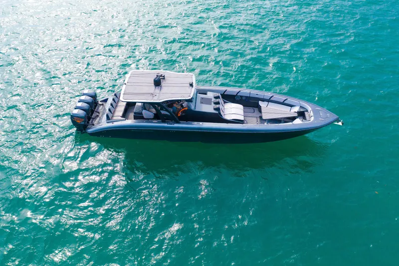 Slide: The Image of 2019 Midnight Express 43 Open boat on turquoise water, aerial view. - 28