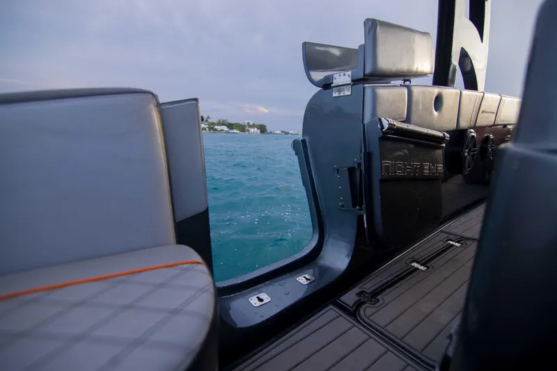 Slide: The Image of 2019 Midnight Express 43 Open boat interior with open door, overlooking serene blue waters. - 12