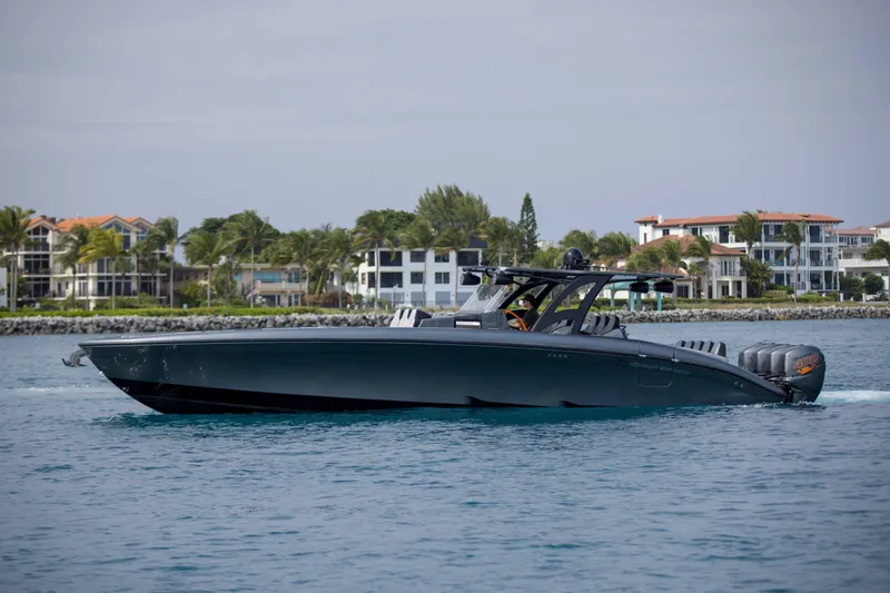 Slide: The Image of 2019 Midnight Express 43 Open boat cruising near luxury waterfront homes. - 4