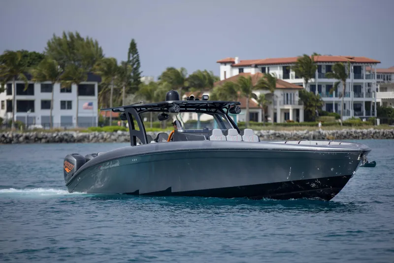 Slide: The Image of 2019 Midnight Express 43 Open boat cruising near luxury waterfront homes. - 30