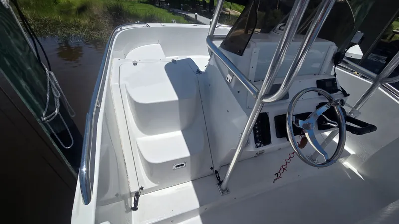 Slide: The Image of The image shows the cockpit of a 2001 Glacier Bay Canyon Runner 2260 with helm and seating area. - 12