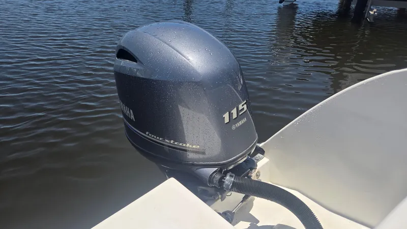 Slide: The Image of A Yamaha 115 outboard motor on a boat in calm water. - 7