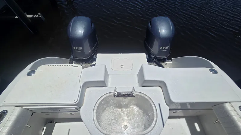 Slide: The Image of Stern view of a boat with two outboard motors and a round sink. - 5