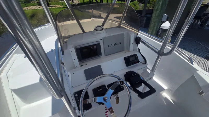 Slide: The Image of The image shows the helm of a 2001 Glacier Bay Canyon Runner 2260 boat. - 10
