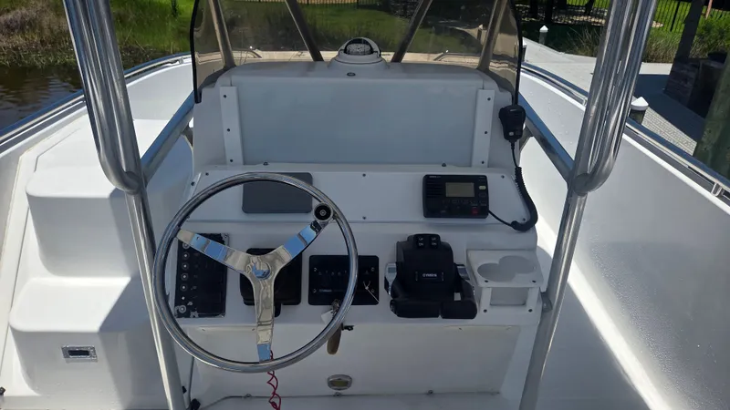 Slide: The Image of The image shows a boat's helm with a steering wheel, instruments, and a radio. - 4