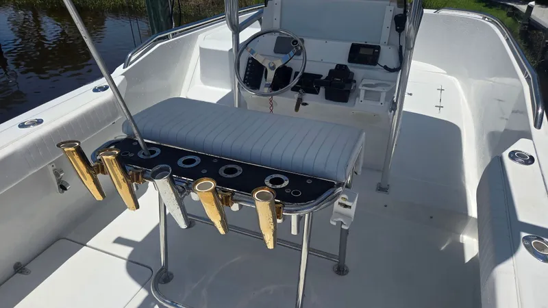 Slide: The Image of The image shows the cockpit of a 2001 Glacier Bay Canyon Runner 2260 with fishing rod holders. - 8