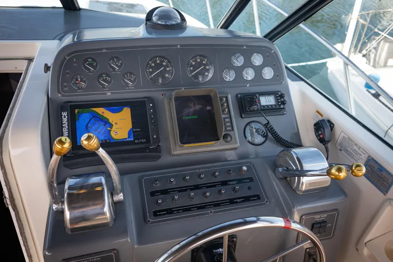 Slide: The Image of Control panel of a 1995 Tiara Yachts 3100 Open, featuring navigation and communication equipment. - 16