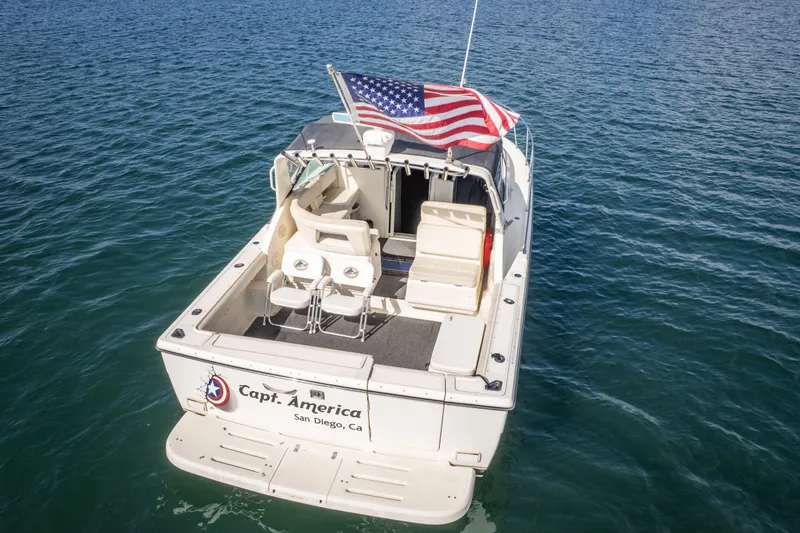 Slide: The Image of 1995 Tiara Yachts 3100 Open boat with American flag, San Diego, on calm water. - 7