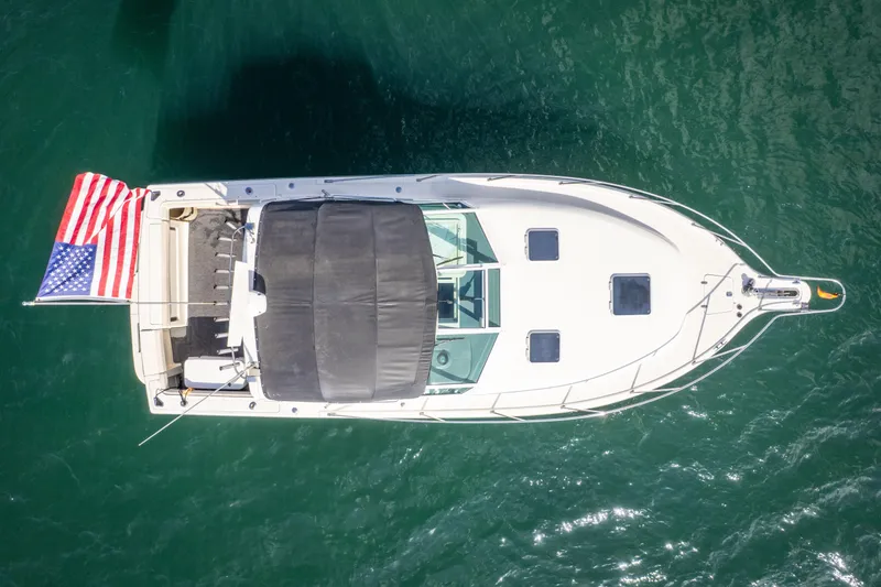 Slide: The Image of Aerial view of 1995 Tiara Yachts 3100 Open boat with American flag on water. - 5