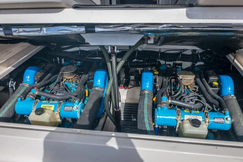 Slide: The Image of Engine compartment of a 1995 Tiara Yachts 3100 Open, showcasing dual blue marine engines. - 21