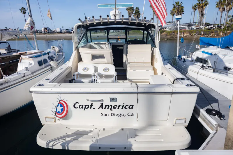 Slide: The Image of 1995 Tiara Yachts 3100 Open docked, named "Capt. America," in San Diego marina. - 18