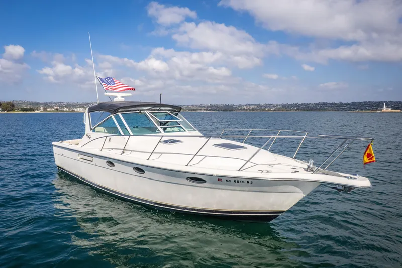 Slide: The Image of 1995 Tiara Yachts 3100 Open cruising on a sunny day with American flag. - 4