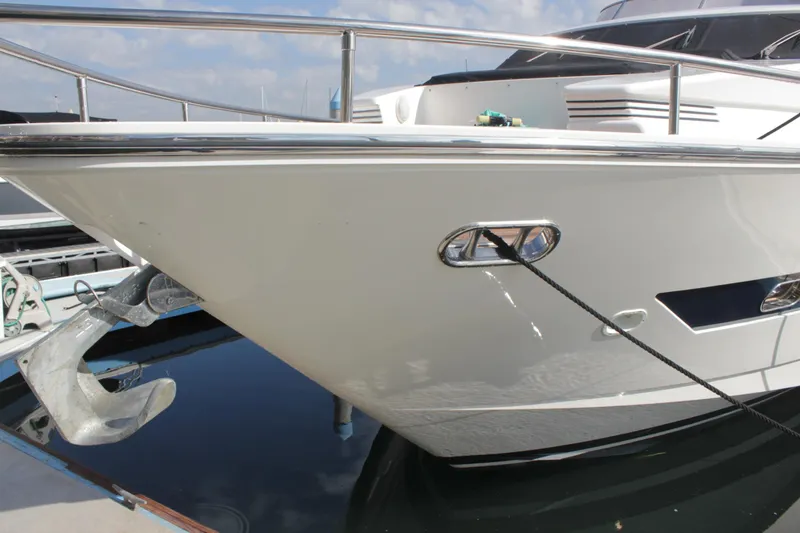 Slide: The Image of Horizon 70 Motor Yacht 1999, sleek bow design, docked with anchor visible. - 6