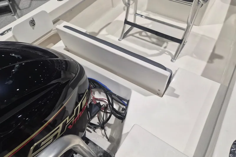 Slide: The Image of Interior view of 2026 Defiance 205 Catalina boat, featuring seating and engine details. - 5