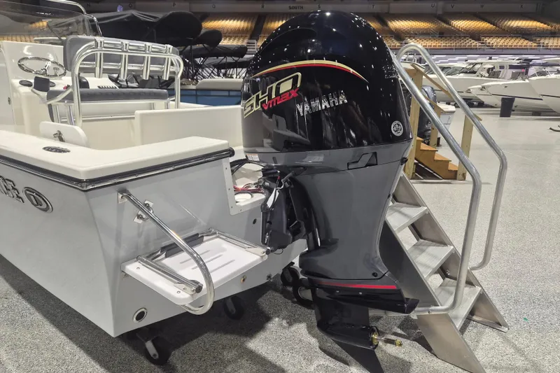 Slide: The Image of 2026 Defiance 205 Catalina boat with Yamaha outboard motor displayed indoors. - 3