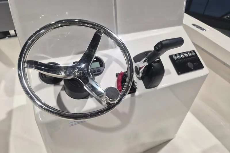 Slide: The Image of Steering console of 2026 Defiance 205 Catalina boat with controls and gauges. - 11